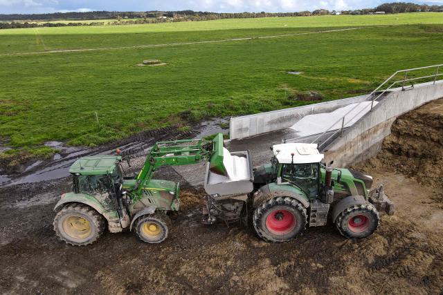 A photo taken on June 22, 2026 shows a tractor with a spreader being loaded before spreading fertiliser on paddocks on a dairy farm near the small rural town of Yanakie, some 190kms south-west of Melbourne. Importing 90 percent of fertilisers, Australia is facing a severe shortage due to the closure of the Strait of Hormuz. (Photo by William WEST / AFP)