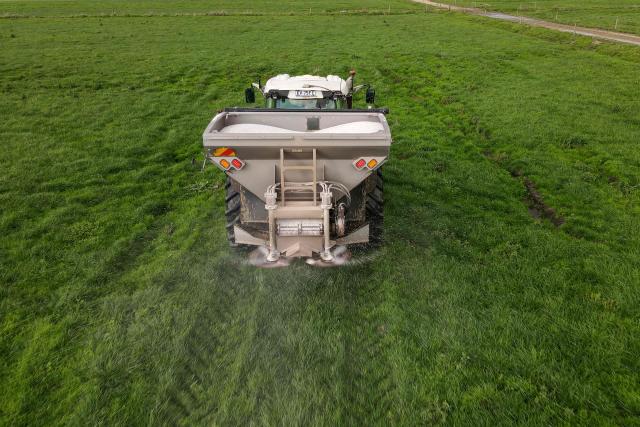 A photo taken on June 22, 2026 shows a tractor with a spreader fertilising paddocks on a dairy farm near the small rural town of Yanakie, some 190kms south-west of Melbourne. Importing 90 percent of fertilisers, Australia is facing a severe shortage due to the closure of the Strait of Hormuz. (Photo by William WEST / AFP)