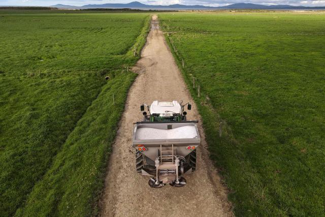 A photo taken on June 22, 2026 shows a tractor with a spreader heading to spread fertiliser on paddocks on a dairy farm near the small rural town of Yanakie, some 190kms south-west of Melbourne. Importing 90 percent of fertilisers, Australia is facing a severe shortage due to the closure of the Strait of Hormuz. (Photo by William WEST / AFP)