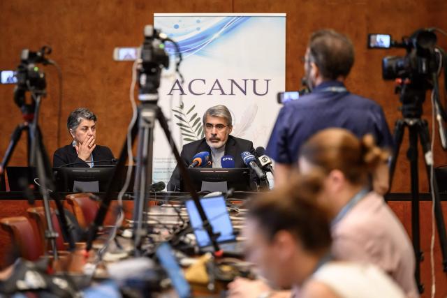 Iranian ambassador to the United Nations in Geneva Ali Bahreini (C) looks on next to ACANU president Dina Abi Saab during a briefing with the UN correspondent's association ACANU, following talks between US and Iran in Switzerland, in Geneva, on June 23, 2026. (Photo by Fabrice COFFRINI / AFP)
