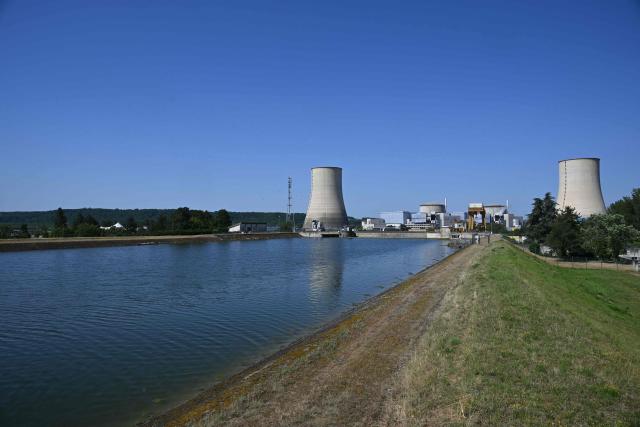 Tis photograph shows a view of the stopped Golfech nuclear power plant in southwestern France is pictured after its shutdown  on June 22 evening, due to "environmental constraints" related to an ongoing heatwave, on June 23, 2026 in Golfech. In periods of extreme heat, rising river temperatures can force EDF to reduce, or even halt, its production in order to avoid further warming the waterways. The operation of the plants is governed by maximum heating thresholds for bodies of water, which must not be exceeded, in order to protect wildlife and plant life. (Photo by Lionel BONAVENTURE / AFP)