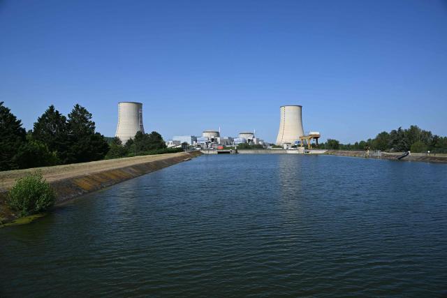Tis photograph shows a view of the stopped Golfech nuclear power plant in southwestern France is pictured after its shutdown  on June 22 evening, due to "environmental constraints" related to an ongoing heatwave, on June 23, 2026 in Golfech. In periods of extreme heat, rising river temperatures can force EDF to reduce, or even halt, its production in order to avoid further warming the waterways. The operation of the plants is governed by maximum heating thresholds for bodies of water, which must not be exceeded, in order to protect wildlife and plant life. (Photo by Lionel BONAVENTURE / AFP)
