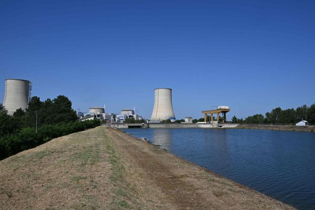 Tis photograph shows a view of the stopped Golfech nuclear power plant in southwestern France is pictured after its shutdown  on June 22 evening, due to "environmental constraints" related to an ongoing heatwave, on June 23, 2026 in Golfech. In periods of extreme heat, rising river temperatures can force EDF to reduce, or even halt, its production in order to avoid further warming the waterways. The operation of the plants is governed by maximum heating thresholds for bodies of water, which must not be exceeded, in order to protect wildlife and plant life. (Photo by Lionel BONAVENTURE / AFP)