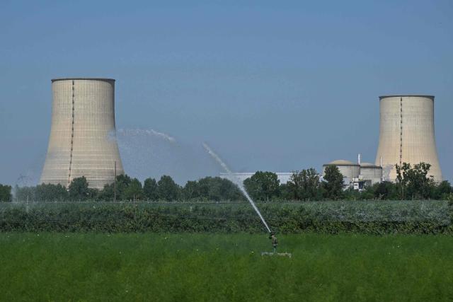 Tis photograph shows a view of the stopped Golfech nuclear power plant in southwestern France after its shutdown on June 22 evening, due to "environmental constraints" related to an ongoing heatwave, in Golfech on June 23, 2026. In periods of extreme heat, rising river temperatures can force EDF to reduce, or even halt, its production in order to avoid further warming the waterways. The operation of the plants is governed by maximum heating thresholds for bodies of water, which must not be exceeded, in order to protect wildlife and plant life. (Photo by Lionel BONAVENTURE / AFP)