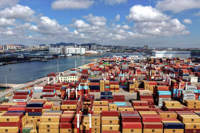 Stacked shipping containers are seen at the container terminal of the Qingdao Port, operated by Shandong Port Group, in eastern China's Shandong province on June 23, 2026. (Photo by CN-STR / AFP) / China OUT