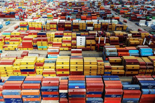 Stacked shipping containers are seen at the container terminal of the Qingdao Port, operated by Shandong Port Group, in eastern China's Shandong province on June 23, 2026. (Photo by CN-STR / AFP) / China OUT
