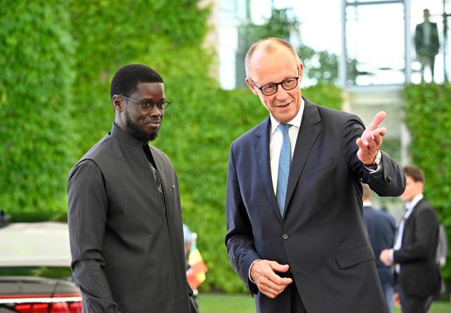 German Chancellor Friedrich Merz (R) welcomes Senegal's President Bassirou Diomaye Faye at the Chancellery in Berlin on June 23, 2026. (Photo by Tobias SCHWARZ / AFP)