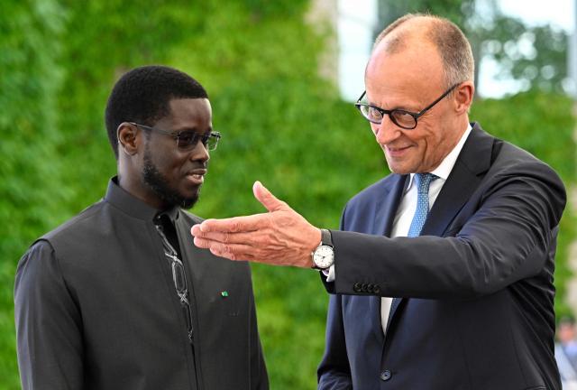 German Chancellor Friedrich Merz (R) welcomes Senegal's President Bassirou Diomaye Faye at the Chancellery in Berlin on June 23, 2026. (Photo by Tobias SCHWARZ / AFP)