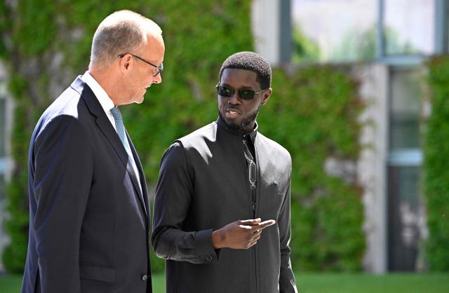 German Chancellor Friedrich Merz (L) welcomes Senegal's President Bassirou Diomaye Faye at the Chancellery in Berlin on June 23, 2026. (Photo by Tobias SCHWARZ / AFP)