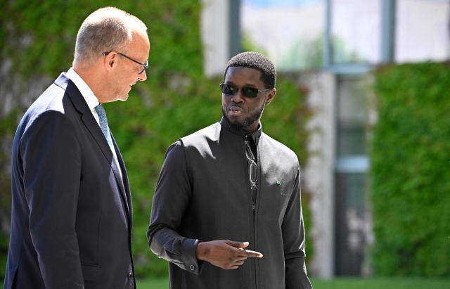 German Chancellor Friedrich Merz (L) welcomes Senegal's President Bassirou Diomaye Faye at the Chancellery in Berlin on June 23, 2026. (Photo by Tobias SCHWARZ / AFP)