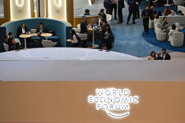 Attendees chat at the Dalian International Conference Centre during the World Economic Forum Annual Meeting of the New Champions in Dalian, China's Liaoning province on June 23, 2026. (Photo by WANG Zhao / AFP)
