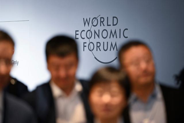 Attendees walk at the Dalian International Conference Centre during the World Economic Forum Annual Meeting of the New Champions in Dalian, China's Liaoning province on June 23, 2026. (Photo by WANG Zhao / AFP)