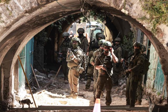 Israeli soldiers gather in an alley while patrolling the market in the Old City of Nablus in the northern Israeli-occupied West Bank on June 23, 2026. Israel has occupied the West Bank since 1967 and violence there has soared since Hamas's October 7, 2023 attack on Israel triggered the Gaza war. (Photo by Jaafar ASHTIYEH / AFP)
