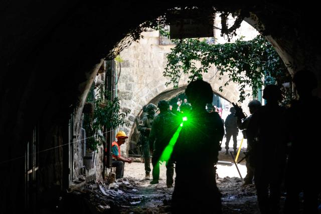 Israeli soldiers use a laser light while patrolling the market in the Old City of Nablus in the northern Israeli-occupied West Bank on June 23, 2026. Israel has occupied the West Bank since 1967 and violence there has soared since Hamas's October 7, 2023 attack on Israel triggered the Gaza war. (Photo by Jaafar ASHTIYEH / AFP)