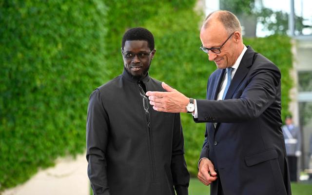 German Chancellor Friedrich Merz (R) welcomes Senegal's President Bassirou Diomaye Faye at the Chancellery in Berlin on June 23, 2026. (Photo by Tobias SCHWARZ / AFP)