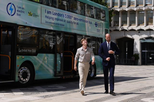 Britain's Prince William, Prince of Wales alongside Australian conservationist Robert Irwin depart a bus to attend the Climate Innovation Forum at the Guildhall in central London, on June 23, 2026.  (Photo by Jordan Pettitt / POOL / AFP)