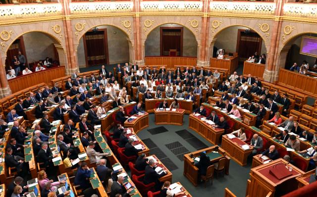 A general view taken on June 23, 2026 shows members of parliament voting in the main hall of Parliament during an extraordinary session of the National Assembly. Hungarian lawmakers on June 23 approved anti-corruption measures, part of new Prime Minister Peter Magyar's sweeping reform drive and aimed at helping the country get billions of euros in withheld European Union funds. The EU announced late last month it would unlock more than 16 billion euros (USD 18 billion) for Hungary that had been frozen over rule-of-law concerns during nationalist Viktor Orban's rule, if Budapest stays on track with a major reform push. (Photo by Attila KISBENEDEK / AFP)