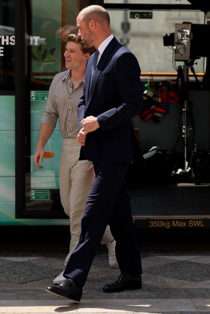 Britain's Prince William, Prince of Wales alongside Australian conservationist Robert Irwin depart a bus to attend the Climate Innovation Forum at the Guildhall in central London, on June 23, 2026. (Photo by Adrian Dennis / AFP)