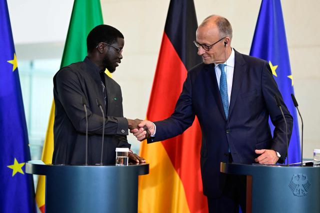 German Chancellor Friedrich Merz (R) and Senegal's President Bassirou Diomaye Faye shake hands at the end of their press conference at the Chancellery in Berlin on June 23, 2026. (Photo by John MACDOUGALL / AFP)