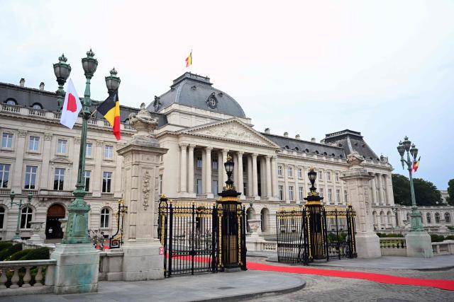 This photograph shows the flags of Japan and Belgium and the red carpet during an official welcoming ceremony as part of a state visit by Japan's Emperor and Empress to Belgium, at the Royal Palace in Brussels on June 23, 2026. (Photo by ERIC LALMAND / Belga / AFP) / Belgium OUT