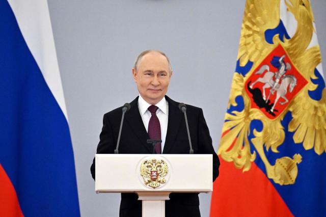 In this pool photograph distributed by the Russian state agency Sputnik, Russia's President Vladimir Putin gives a speech during a meeting with graduates of higher military educational institutions at the Kremlin in Moscow on June 23, 2026. (Photo by Yuri KOCHETKOV / POOL / AFP)