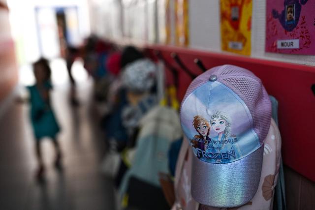 This photograph shows a child's hat at the Jean Ponsy School in Grabels, near Montpellier, Southern France, where the Racine programme is being tested to reduce the temperature by 7 degrees Celsius on June 23, 2026. The Racine programme is a set of sun protection, refreshments and ventilation. (Photo by Gabriel BOUYS / AFP)