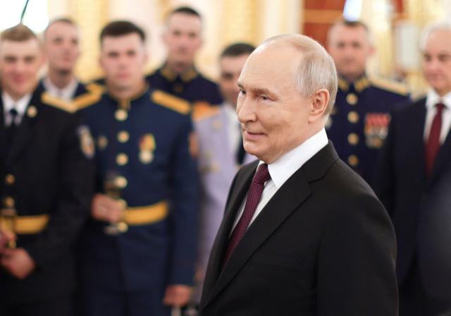 In this pool photograph distributed by the Russian state agency Sputnik, Russia's President Vladimir Putin attends a meeting with graduates of higher military educational institutions at the Kremlin in Moscow on June 23, 2026. (Photo by Gavriil Grigorov / POOL / AFP)