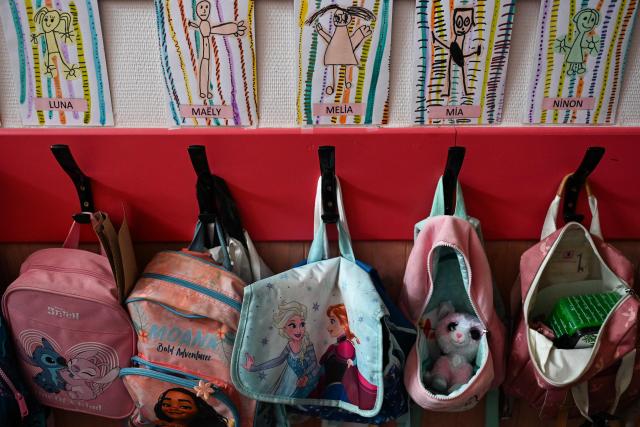 This photograph shows schoolbags at the Jean Ponsy School in Grabels, near Montpellier, Southern France, where the Racine programme is being tested to reduce the temperature by 7 degrees Celsius on June 23, 2026. The Racine programme is a set of sun protection, refreshments and ventilation. (Photo by Gabriel BOUYS / AFP)