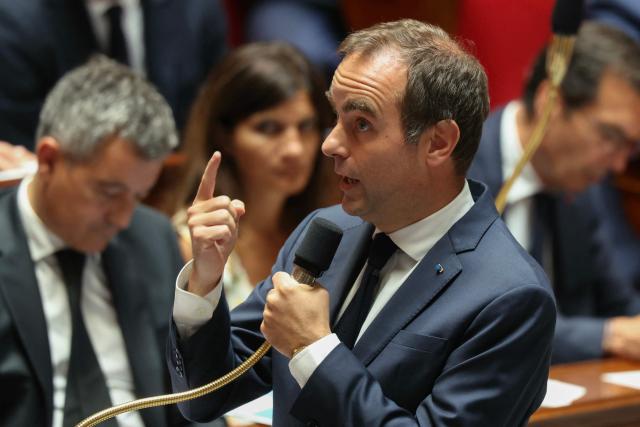 France's Justice Minister Gerald Darmanin (L) sits next to France's Prime minister Sebastien Lecornu addressing MPs during a session of questions to the government at The National Assembly, France's lower house of parliament in Paris on June 23, 2026. (Photo by Alain JOCARD / AFP)