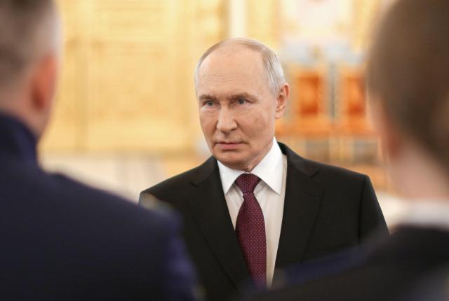 In this pool photograph distributed by the Russian state agency Sputnik, Russia's President Vladimir Putin talks to graduates of higher military educational institutions during a meeting at the Kremlin in Moscow on June 23, 2026. (Photo by Gavriil Grigorov / POOL / AFP)