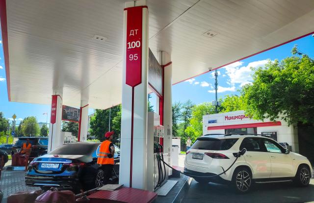 People refuel their cars at a petrol station in Moscow on June 23, 2026. (Photo by Alexander NEMENOV / AFP)