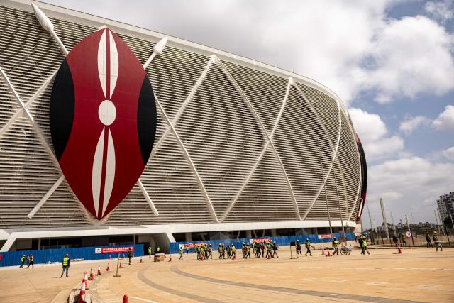 Construction workers walk during a break at the Raila Odinga International Stadium, also known as Talanta Sports Stadium, a 60,000-seat national stadium under construction in Nairobi on June 23, 2026, ahead the Africa Cup of Nations (AFCON) scheduled for 2027. (Photo by SIMON MAINA / AFP)