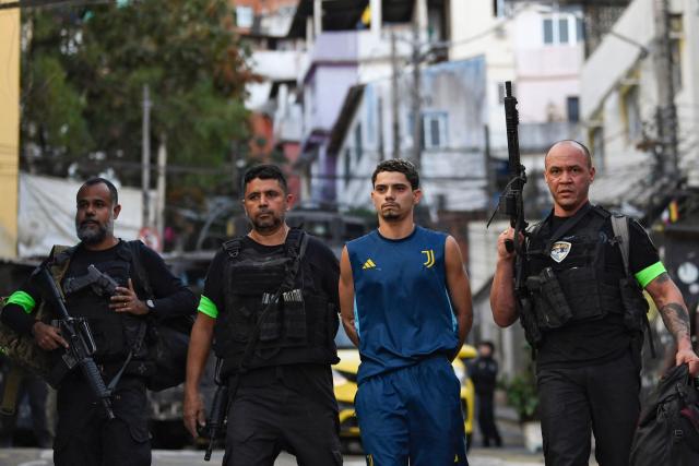 Brazilian Special Police forces arrest a suspect during the Operation Containment at the Santa Marta favela, in Rio de Janeiro, Brazil, on June 23, 2026. The operation targets alleged members linked to the Comando Vermelho drug trafficking organization as authorities seek to contain the gang's territorial expansion and dismantle its criminal infrastructure. (Photo by Daniel RAMALHO / AFP)