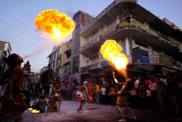 Revellers perform fire-breathing stunts during a religious procession to celebrate the Hindu festival of 'Mahesh Navami' in Ajmer on June 23, 2026. (Photo by HIMANSHU SHARMA / AFP)