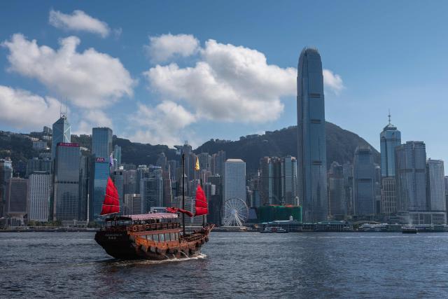 A tour boat sails across Victoria Harbour in Hong Kong on June 22, 2026. (Photo by Dale DE LA REY / AFP)