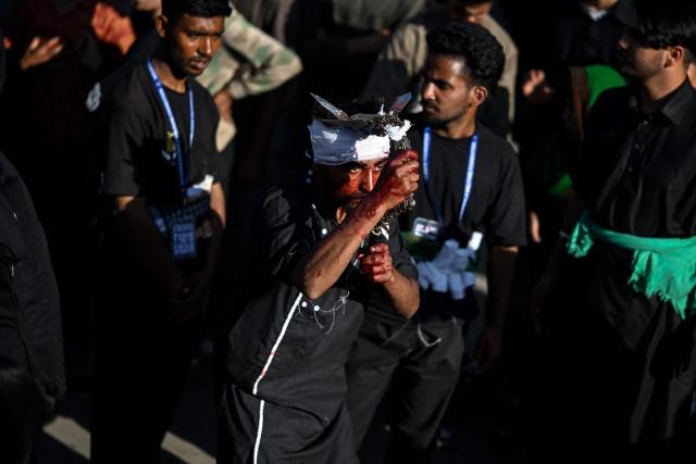 EDITORS NOTE: Graphic content / A Kashmiri Shia mourner self-flagellates during a religious procession on the seventh day of Ashura during the Islamic holy month of Muharram in Srinagar on June 23, 2026. (Photo by Tauseef MUSTAFA / AFP)