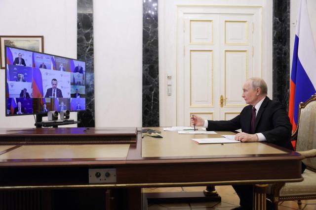 In this pool photograph distributed by the Russian state agency Sputnik, Russia's President Vladimir Putin chairs a meeting with members of the government via videoconference in Moscow on June 23, 2026. (Photo by Gavriil Grigorov / POOL / AFP)