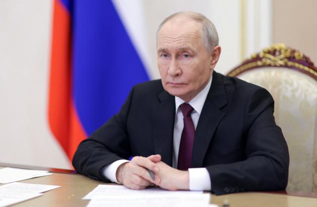 In this pool photograph distributed by the Russian state agency Sputnik, Russia's President Vladimir Putin chairs a meeting with members of the government via videoconference in Moscow on June 23, 2026. (Photo by Gavriil Grigorov / POOL / AFP)