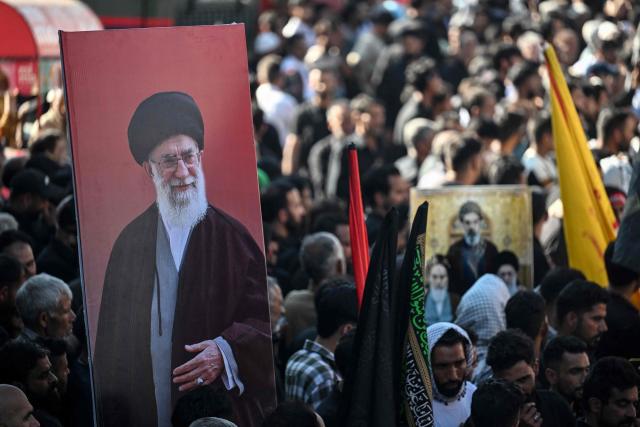 Kashmiri Shia mourners hold a portrait of Iran's late supreme leader Ayatollah Ali Khamenei during a religious procession on the seventh day of Ashura during the Islamic holy month of Muharram in Srinagar on June 23, 2026. (Photo by Tauseef MUSTAFA / AFP)