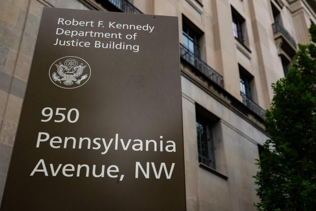 A sign is seen outside of the Department of Justice headquarters ahead of a press conference with Acting Attorney General Todd Blanche announcing annual healthcare fraud takedown results in Washington, DC on June 23, 2026. (Photo by Ken Cedeno / AFP)