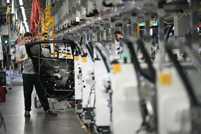 (FILES) An employee works on a production line on the sidelines of a ministerial visit to the Stellantis automotive manufacturer factory in Sausheim, near Mulhouse, eastern France, on June 2, 2026. The CGT union at the Stellantis plant in Mulhouse has filed a strike notice from June 23 to June 28, 2026, to protest the working conditions of employees suffering from the extreme heat. (Photo by SEBASTIEN BOZON / AFP)
