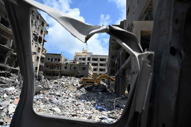 A gigger is used as workers remove the rubble of a building from the site of an earlier Israeli military strike on a neighbourhood in the southern Lebanese coastal city of Tyre on June 23, 2026. On June 22, 2026, mediators Pakistan and Qatar said that Tehran and Washington had agreed to set up a "de-confliction cell" to limit flare-ups in Lebanon following talks in Switzerland on ending the wider Middle East war, which Tehran has linked to halting the parallel conflict in Lebanon. (Photo by Joseph EID / AFP) / 