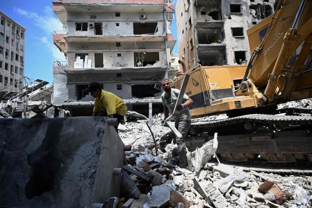 Workers remove the rubble of a building from the site of an earlier Israeli military strike on a neighbourhood in the southern Lebanese coastal city of Tyre on June 23, 2026. On June 22, 2026, mediators Pakistan and Qatar said that Tehran and Washington had agreed to set up a "de-confliction cell" to limit flare-ups in Lebanon following talks in Switzerland on ending the wider Middle East war, which Tehran has linked to halting the parallel conflict in Lebanon. (Photo by Joseph EID / AFP) / 