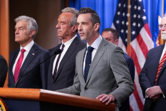 Acting Deputy Executive Associate Director of Homeland Security Investigations (HSI) Matthew Millhollin (C) speaks during a press conference announcing annual healthcare fraud takedown results at the Department of Justice in Washington, DC on June 23, 2026. (Photo by Ken Cedeno / AFP)