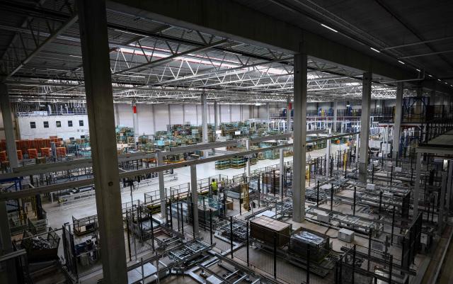 A general view of packaging stations a warehouse of the new Daimler Truck Global Parts Center (GPC) in Halberstadt, eastern Germany, on June 23, 2026. Following its opening in 2025, the company has brought the logistics center fully online and now ships to 170 countries worldwide. (Photo by Ronny HARTMANN / AFP)