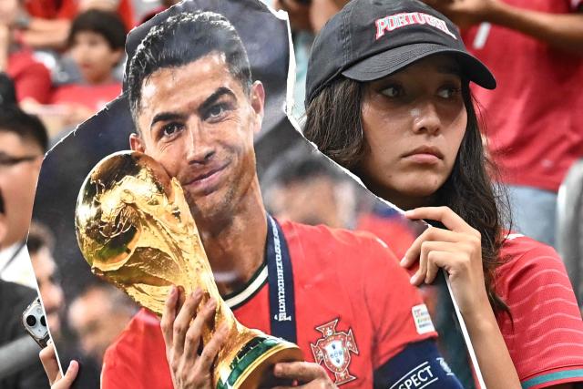 A Portugal supporter holds a cardboard sign featuring Cristiano Ronaldo holding the World Cup trophy ahead of the 2026 World Cup Group K football match between Portugal and Uzbekistan at the Houston Stadium in Houston on June 23, 2026.  (Photo by Paul ELLIS / AFP)