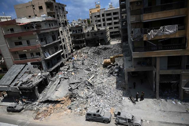 Workers clear the rubble from a building at the site of an earlier Israeli military strike on a neighbourhood in the southern Lebanese coastal city of Tyre on June 23, 2026. On June 22, 2026, mediators Pakistan and Qatar said that Tehran and Washington had agreed to set up a "de-confliction cell" to limit flare-ups in Lebanon following talks in Switzerland on ending the wider Middle East war, which Tehran has linked to halting the parallel conflict in Lebanon. (Photo by Joseph EID / AFP) / 
