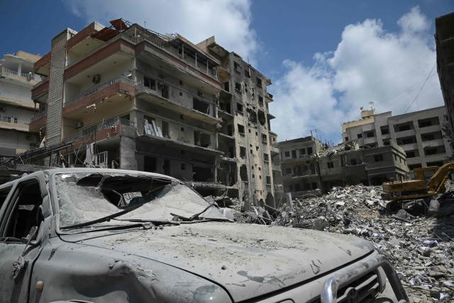 Workers clear the rubble of a building at the site of an earlier Israeli military strike on a neighbourhood in the southern Lebanese coastal city of Tyre on June 23, 2026. On June 22, 2026, mediators Pakistan and Qatar said that Tehran and Washington had agreed to set up a "de-confliction cell" to limit flare-ups in Lebanon following talks in Switzerland on ending the wider Middle East war, which Tehran has linked to halting the parallel conflict in Lebanon. (Photo by Joseph EID / AFP) / 