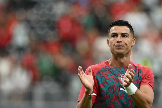 Portugal's forward #07 Cristiano Ronaldo applauds during warm up prior to the  2026 World Cup Group K football match between Portugal and Uzbekistan at the Houston Stadium in Houston on June 23, 2026.  (Photo by RONALDO SCHEMIDT / AFP)
