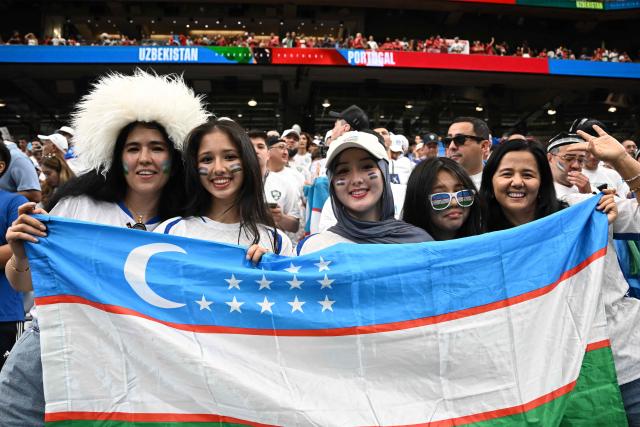 Uzbekistan's supporters cheer ahead of the 2026 World Cup Group K football match between Portugal and Uzbekistan at the Houston Stadium in Houston on June 23, 2026.  (Photo by Paul ELLIS / AFP)
